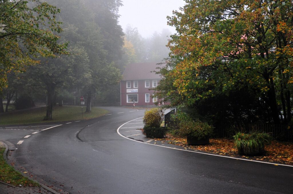 Neblige Herbststraße mit roten Backsteinhäusern in Clausthal-Zellerfeld